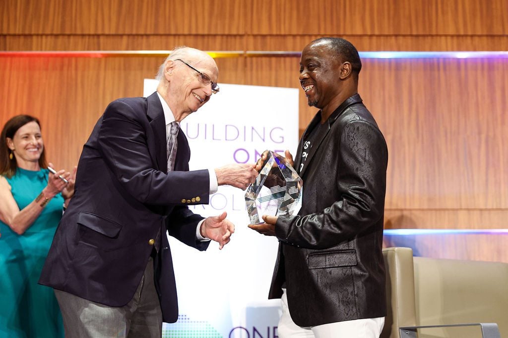 Dick Riley congratulates Terrance Ferrell onstage