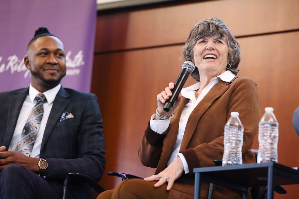 Molly Spearman laughs and talks while Edward Anderson looks on