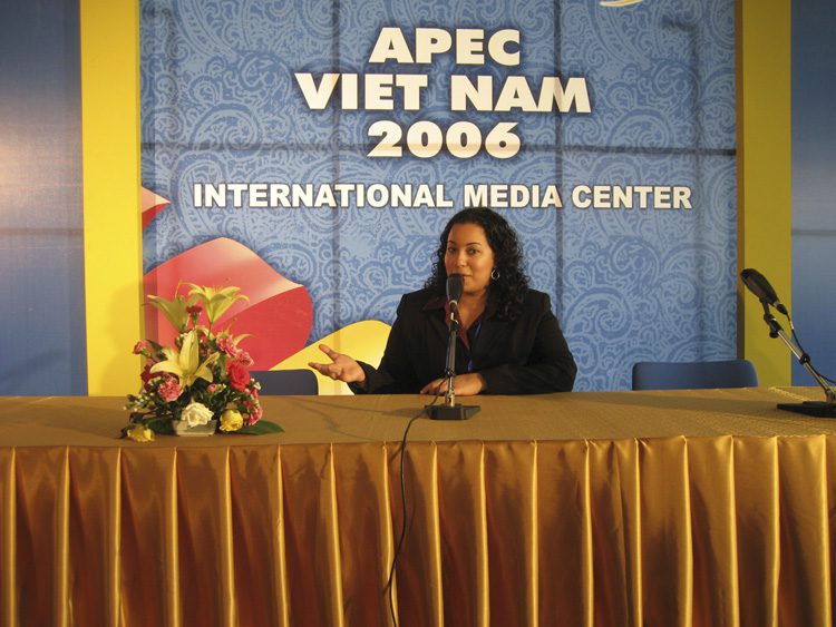 Cindy Youssef sitting at the press conference table where the business leaders will be interviewed by the media