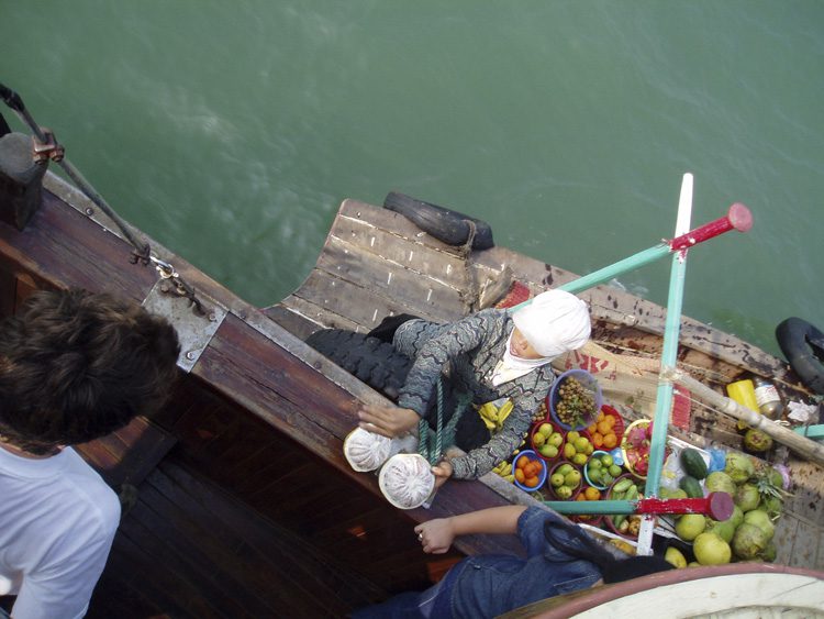 Selling the fruit to passing boats