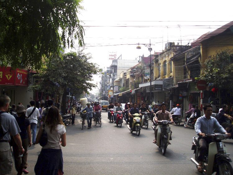 (far left, bottom) Brent Nelsen and Ke Ji walking on the streets of Hanoi, Vietnam