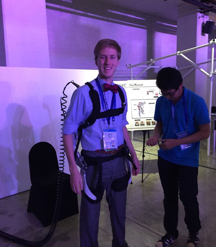 Student Nathan Thompson tries out one of the exhibits at the APEC SME Summit