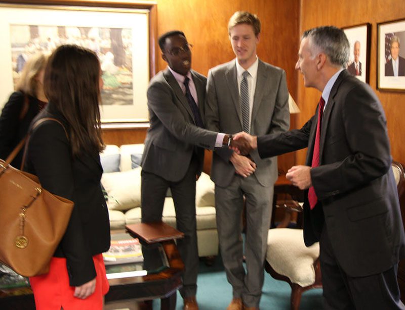 Student Jonathan Kubakundimana meets Ambassador Goldberg upon arrival at the embassy.