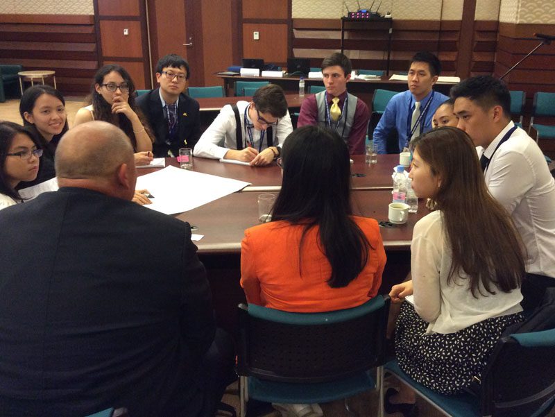 U.S. delegate Matthew Deininger meets with his small group to discuss ways the member economies can address economic issues.