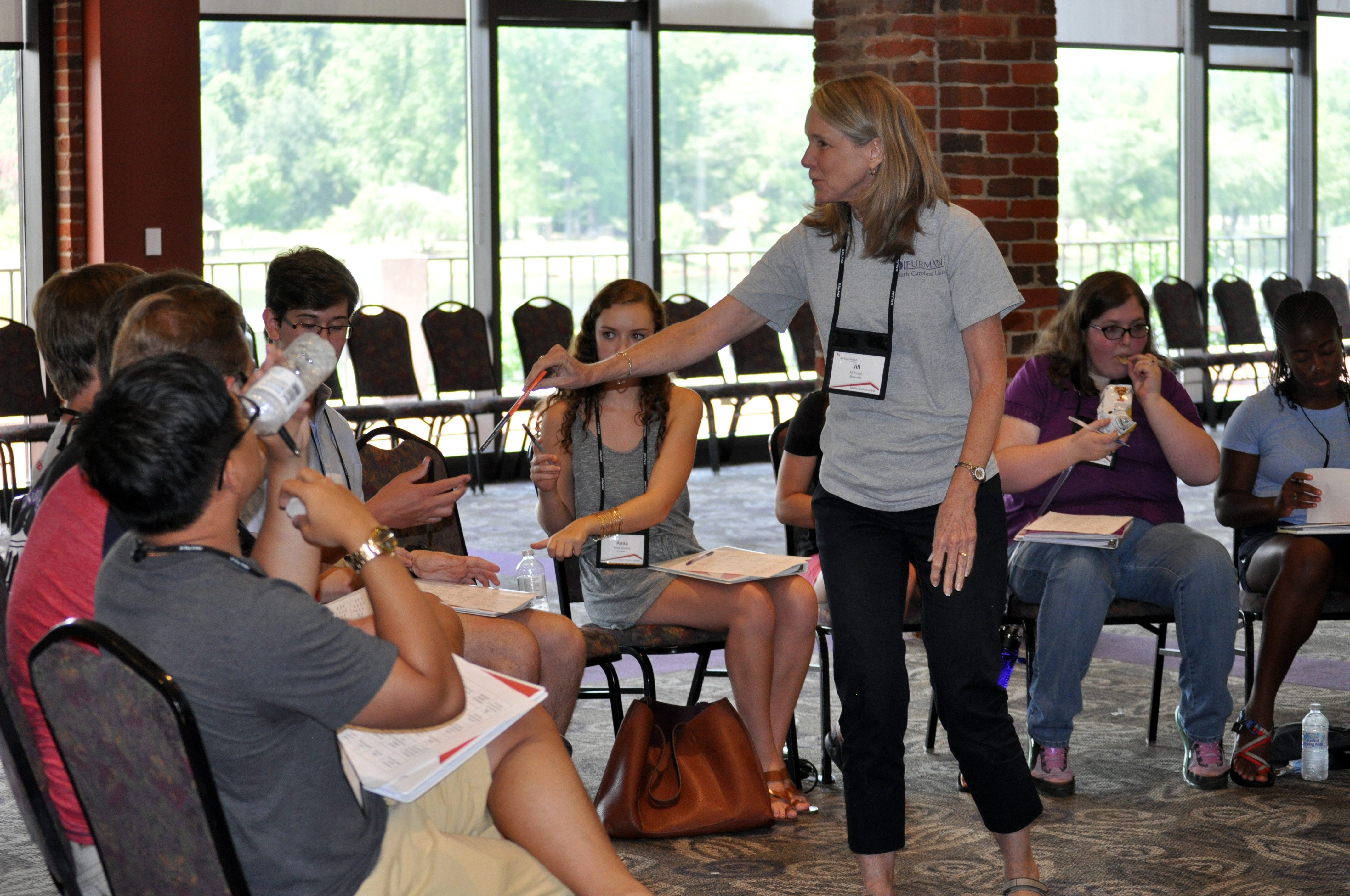 Jill Fuson passing out gifts to the winners of the exploring privilege and understanding poverty exercise