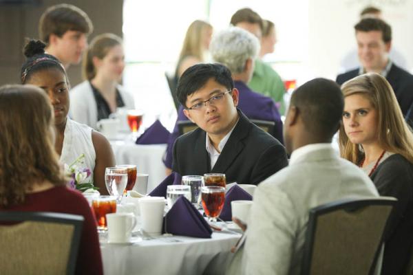 Students enjoying casual conversation with Maurice Owens '00, head of Washington D.C. office and manager of policy and government affairs, Libra Group
