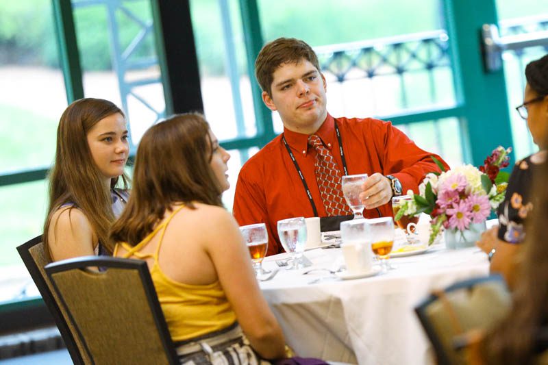 Maddie Tedrick, Rorie Vander Ploeg, and Andrew Ricciardi enjoy the Welcome Dinner at the start of the Advantage Scholars program