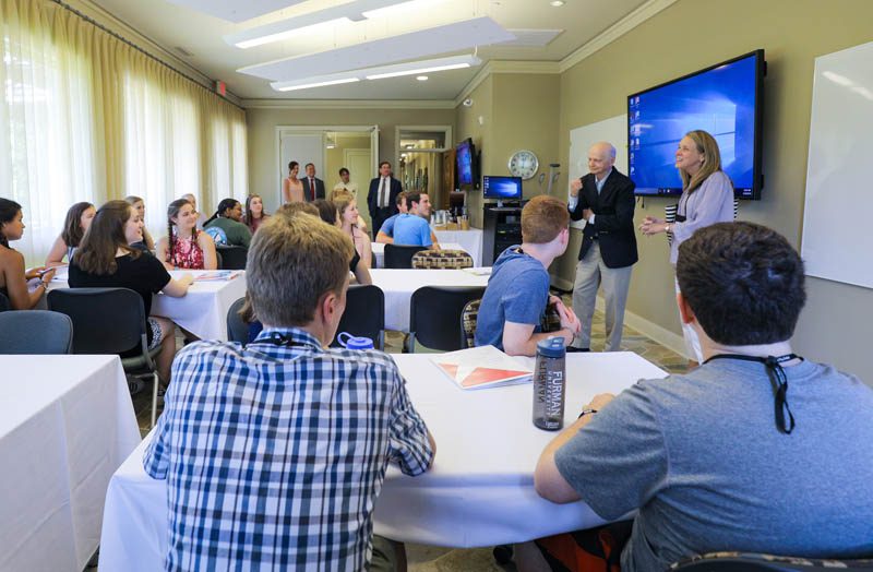 The scholars are addressed by Secretary Riley at the Shi Center for Sustainability