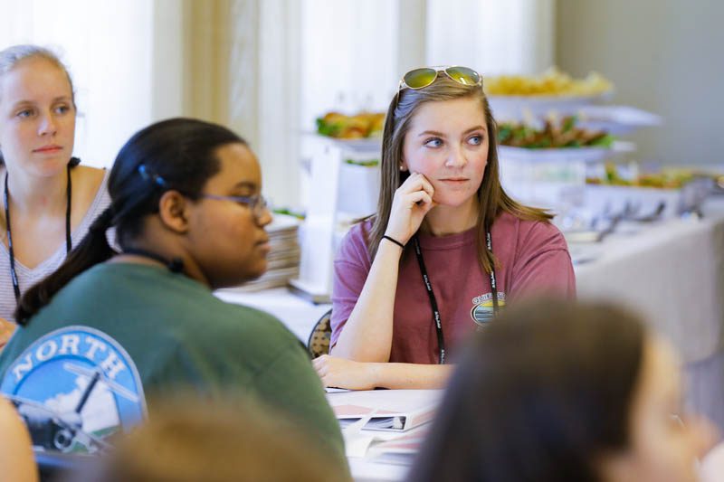 Lauren Allen and Alana Miller attentively listen to Secretary Riley