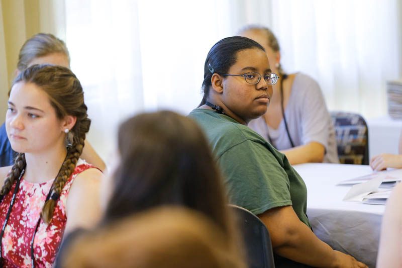 Shaelyn Rivers-Green attentively listens to Secretary Riley at the Shi Center for Sustainability