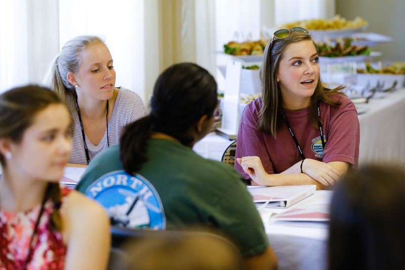 Lauren Allen and Alana Miller attentively listen to Secretary Riley at the Shi Center for Sustainability
