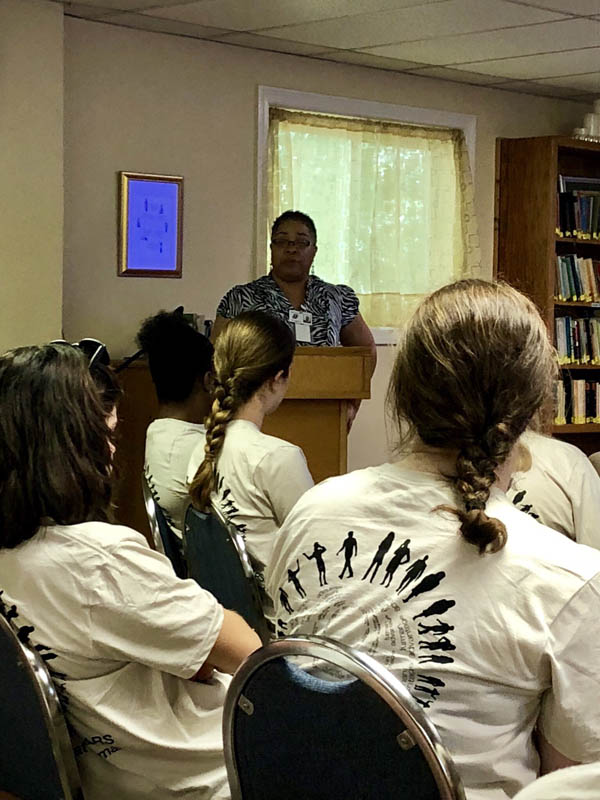 Community advocates address the scholars about the needs in Nicholtown