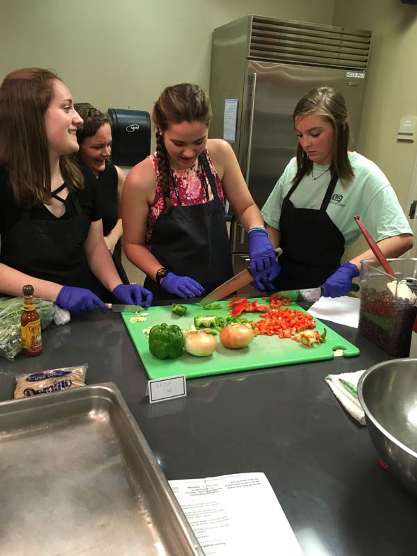 Leanne Joyce, Maddie Tedrick, and Alana Miller are pictured here during a cooking class