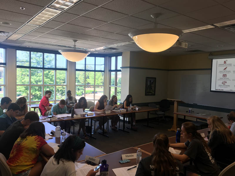 The scholars complete an activity during Dr. Vinson's talk on Fake News