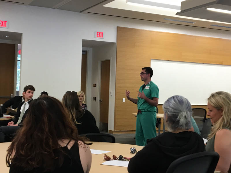 The scholars are addressed by a physician at Greenville Health System