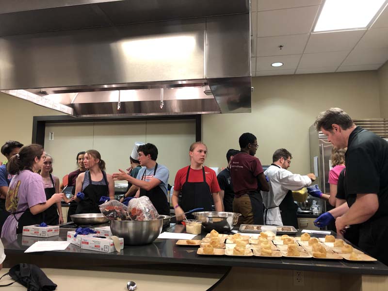 Everyone pitching in to prepare the meal