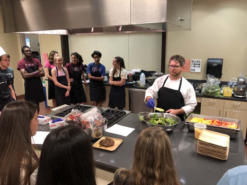 Cooking class with Bon Appetit using locally sourced vegetables