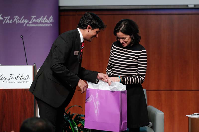 Advance Team member Johnny Aluri presenting a gift of appreciation to guest speaker Angela Maria Kelley