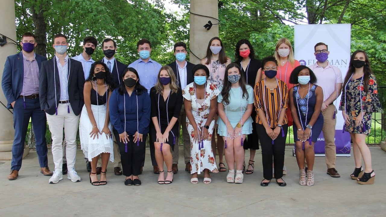 Group photo of 2021 graduating scholars who are wearing their graduation cords