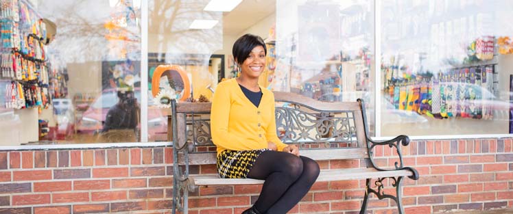 Community Works leader sitting on bench