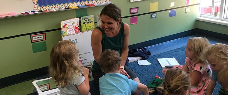 Teacher working with young students