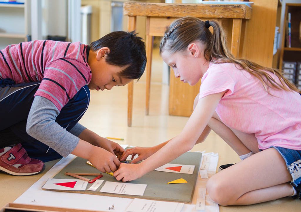 Children working on a Montessori assignment