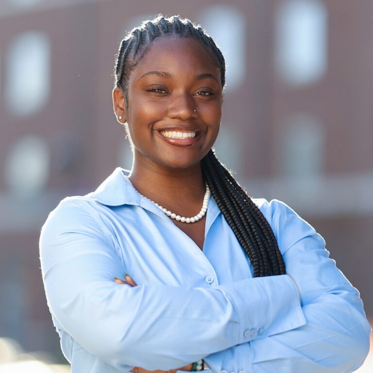 A girl in a blue shirt crossing her arms