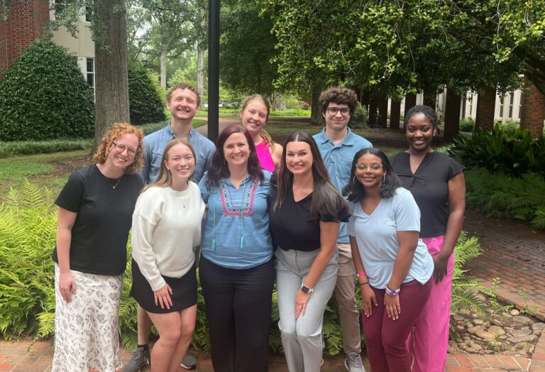 Woman posing with student interns