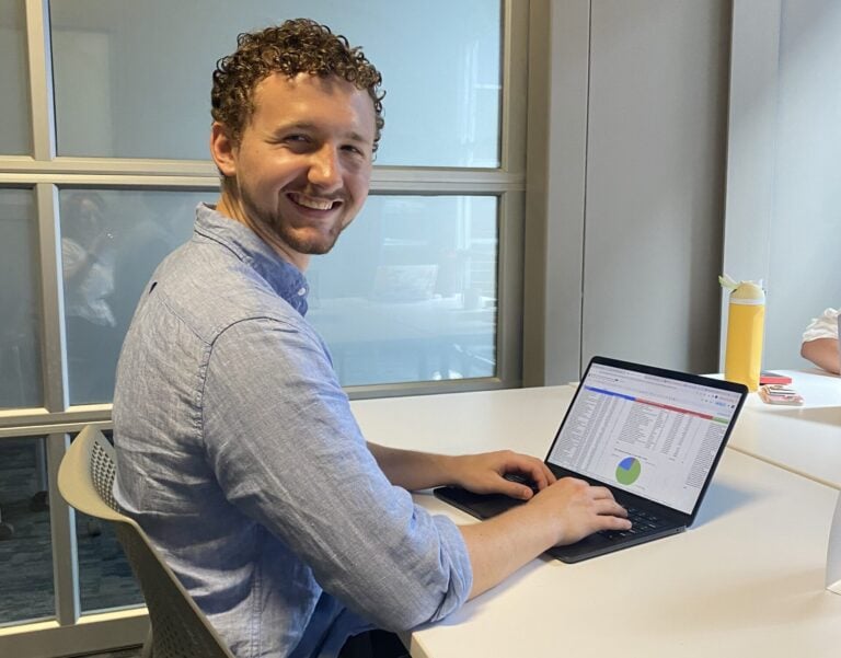 Nathan Johnson works on a computer as he interns for Greater Good Greenville.
