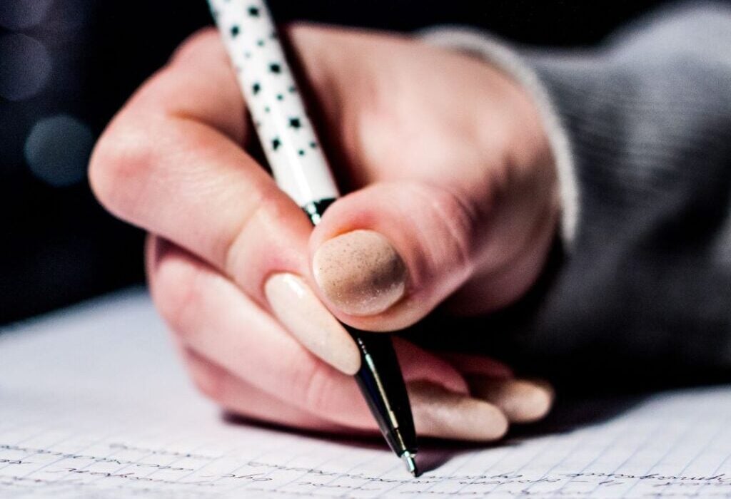 Woman's hand writing on a notepad