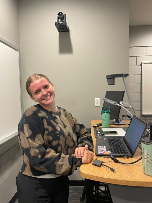 Student standing at computer