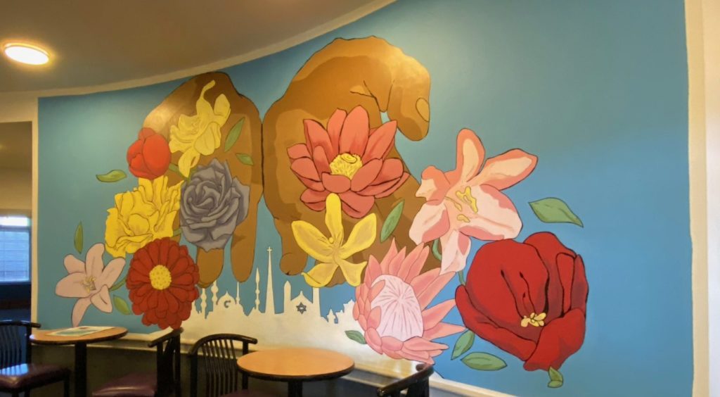Mural of hands holding flowers