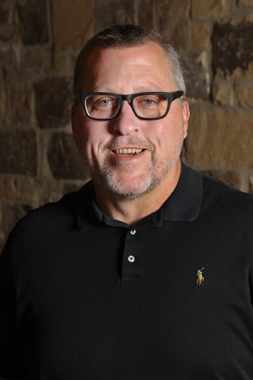 Caucasian man with black glasses and black shirt named Tom Legrand