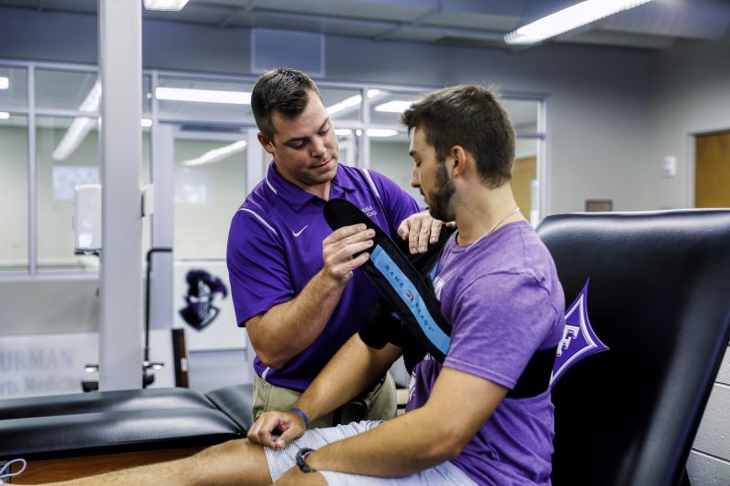 Student athlete receiving treatment on shoulder