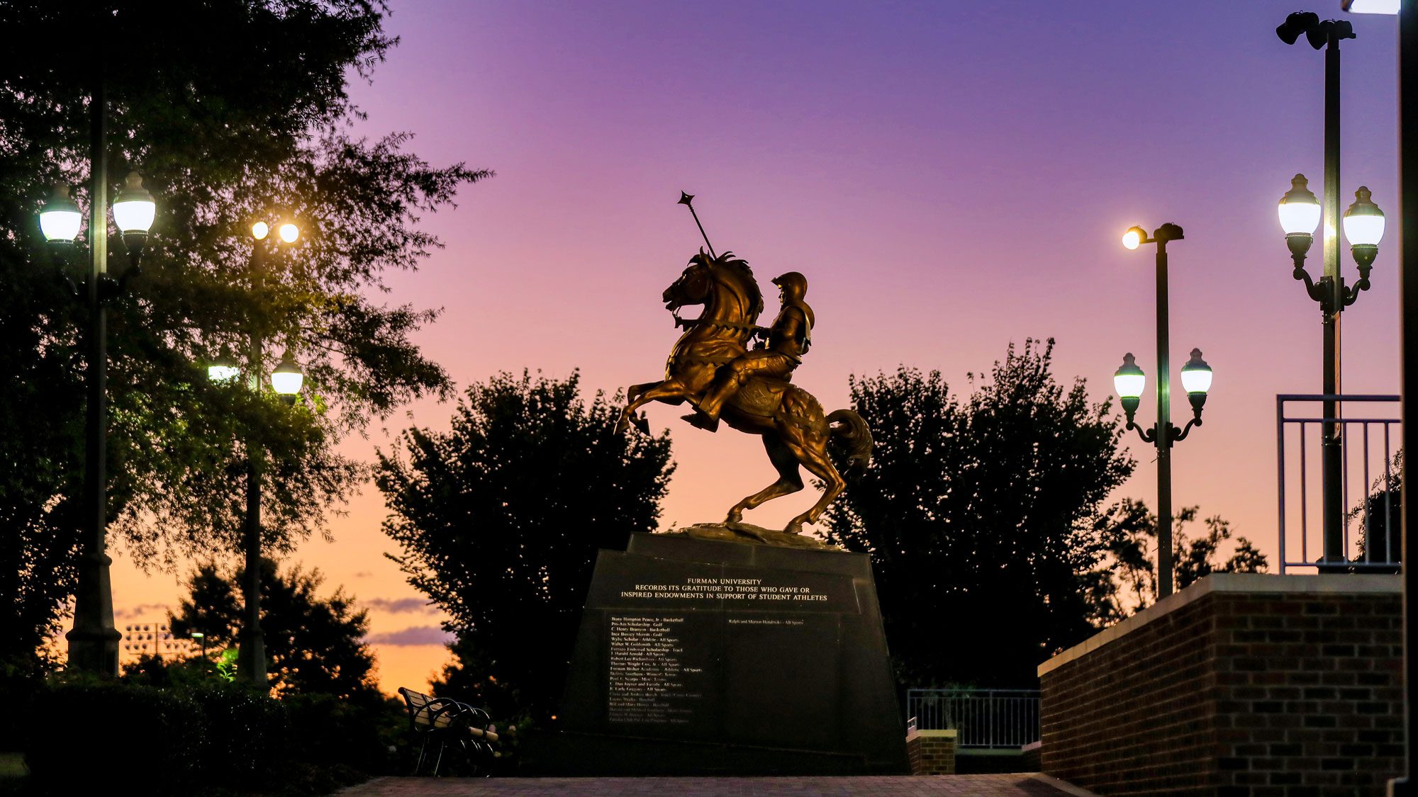 Statue of horse and paladin at sunset