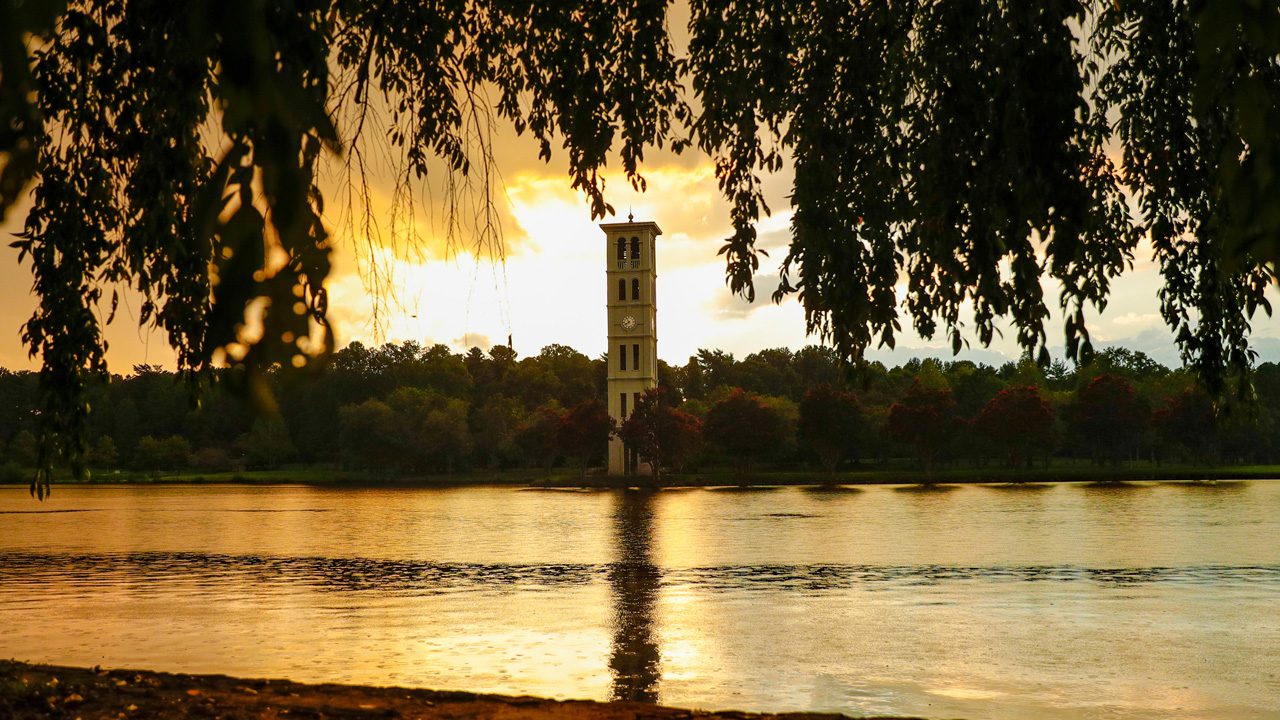 Bell tower on the lake at sunset