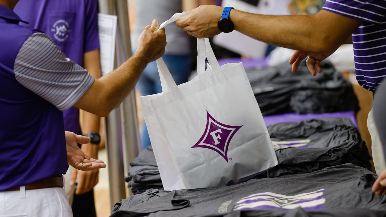 Parent receiving Furman reusable bag