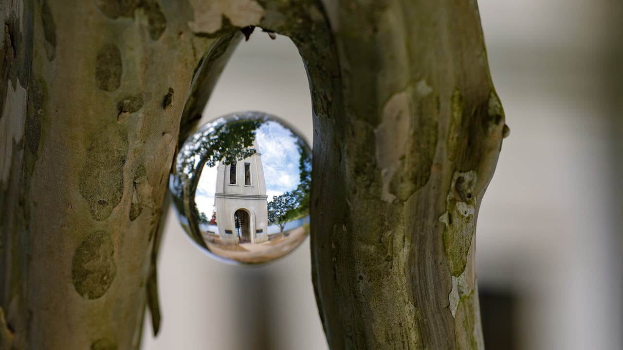 Furman Bell tower in the reflection of a shiny metal ball