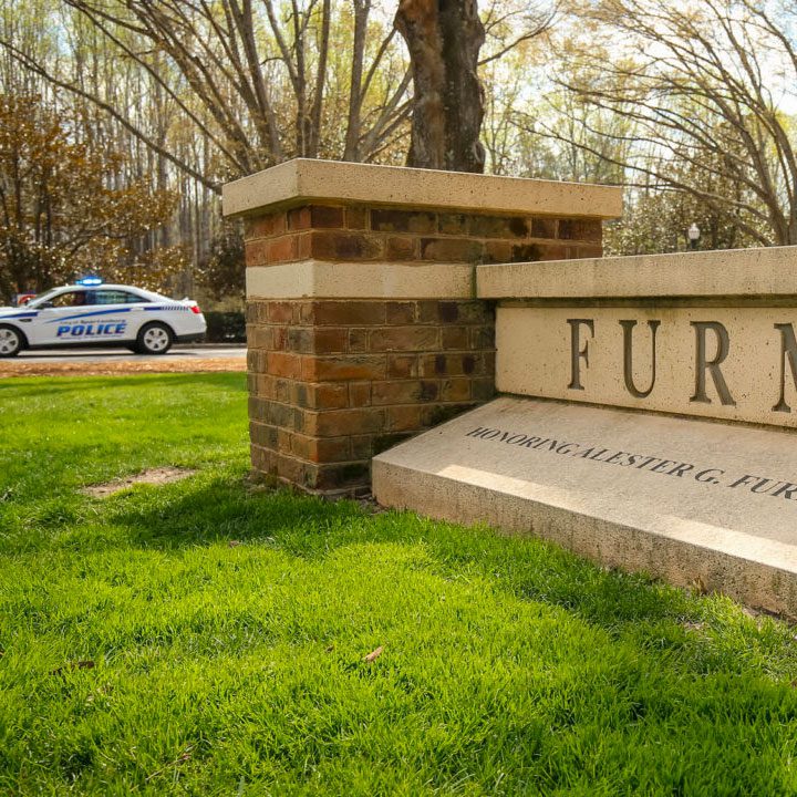 Furman front sign with police car in background