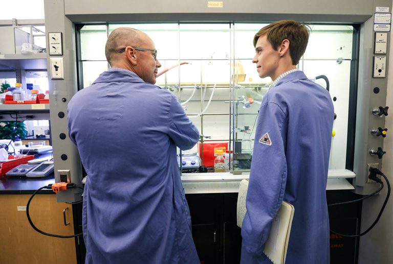 Student and professor working in a science lab