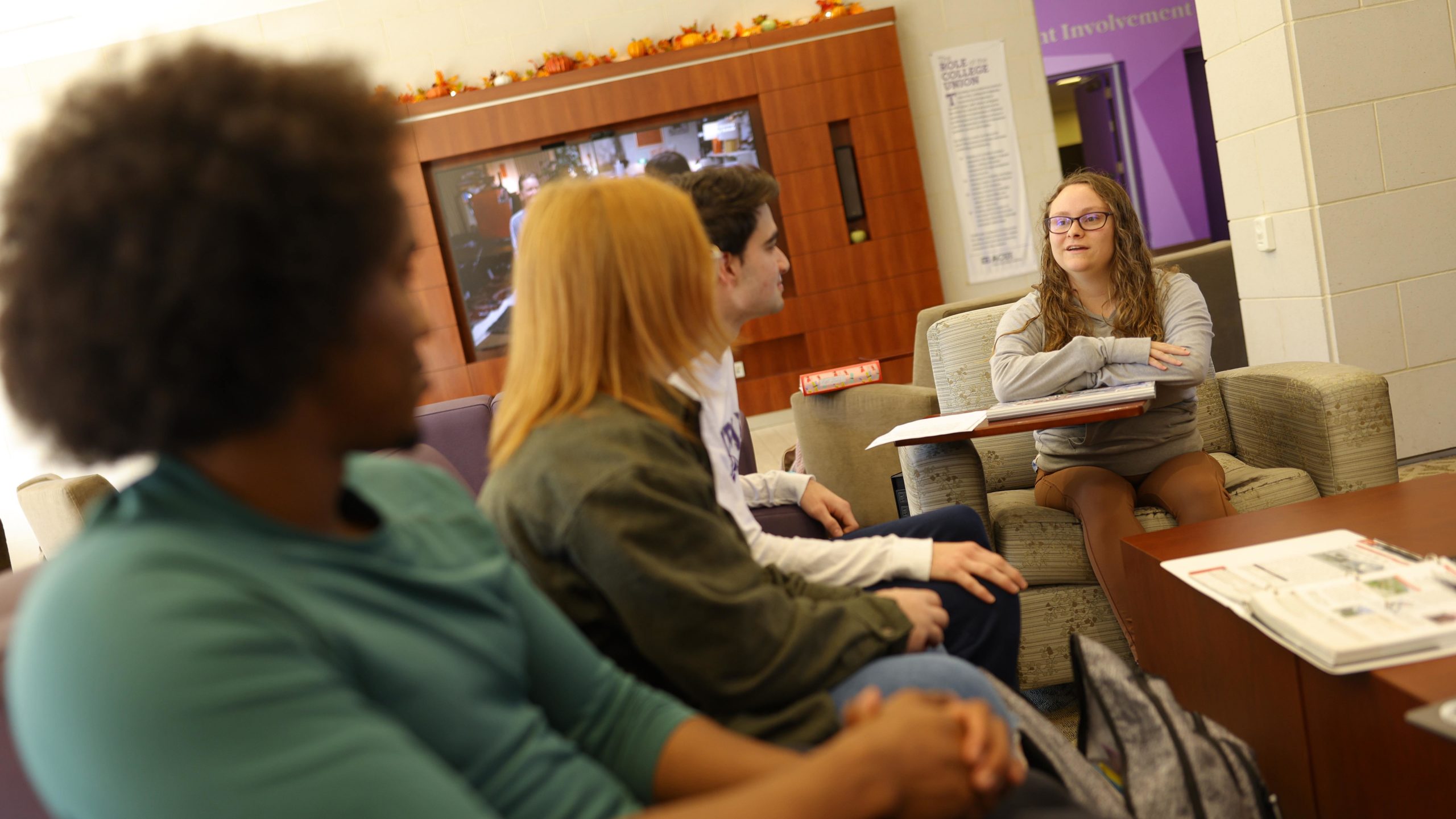 Group of students enjoying the comfy seating and space inside Trone
