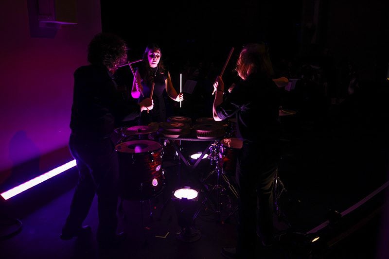 Students play percussion during a live concert performance