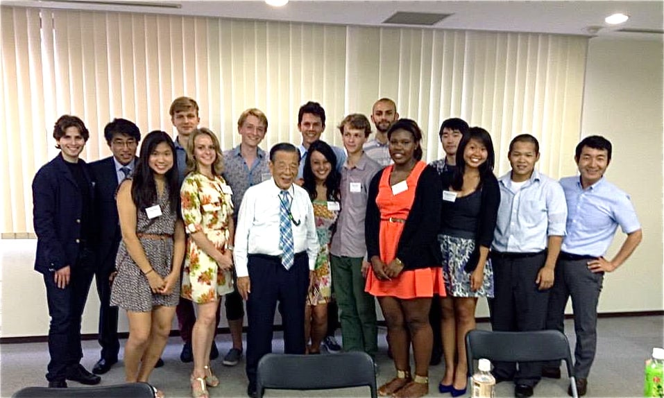 Elisa Edmondson (red dress) and other interns are pictured with Yoshiomi Tami, the founder of Ashinaga.