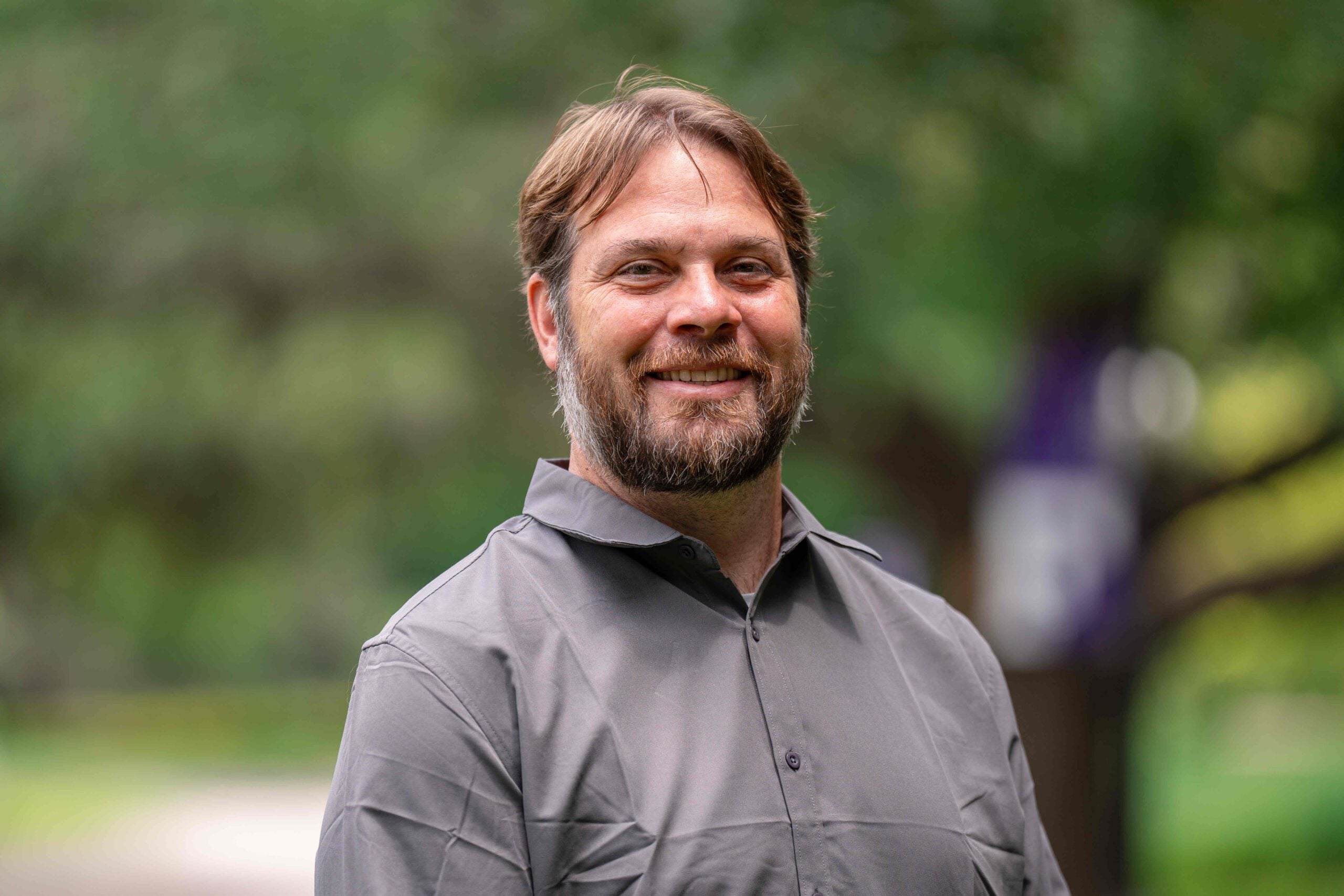 Jake Grove, Director of Editorial Content, stands on the campus of Furman University.