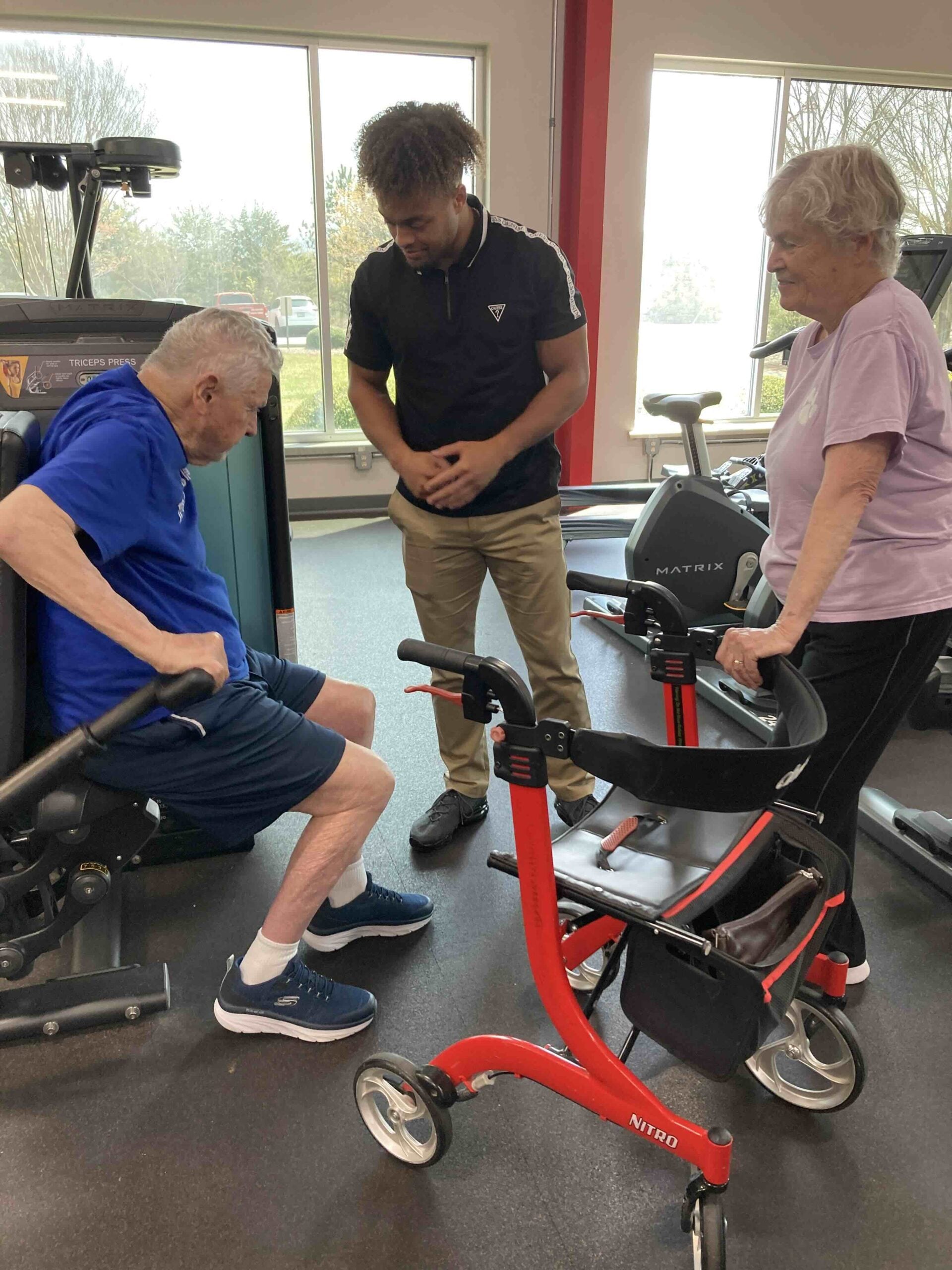 A student does physical therapy with an older gentleman